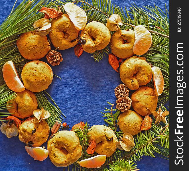 Christmas decoration made of baked rolls, tangerine slices and pine needles. Christmas decoration made of baked rolls, tangerine slices and pine needles