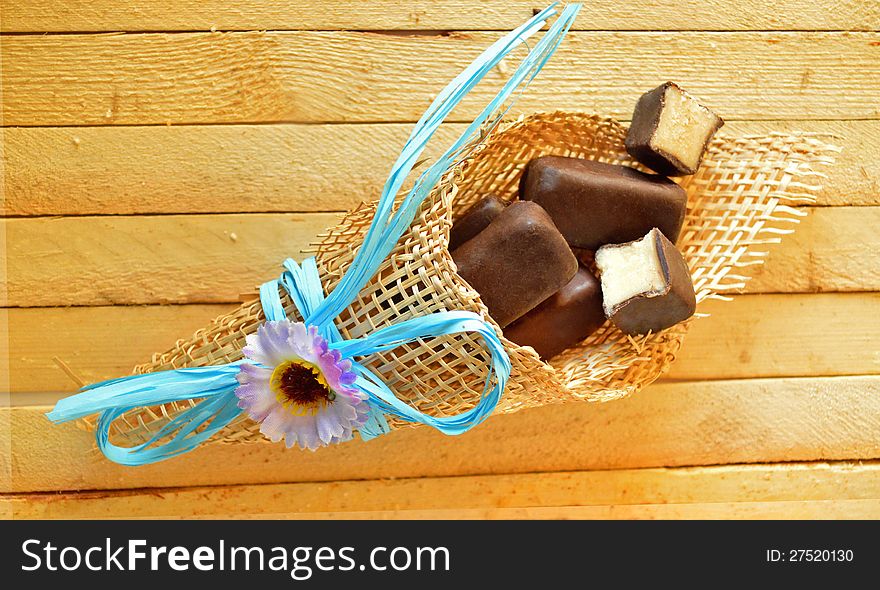 Bunch of chocolate candies with artificial flower. Bunch of chocolate candies with artificial flower