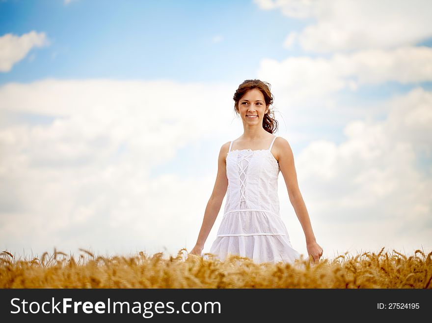 Smiling Woman In White Dress In Field