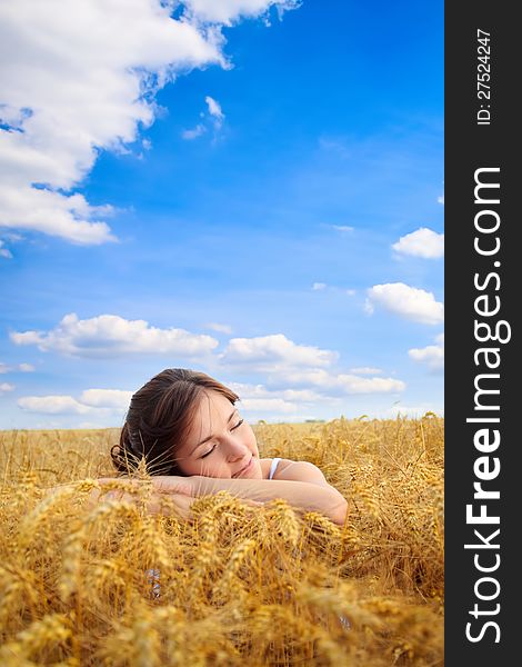 Young pretty woman on yellow wheat field