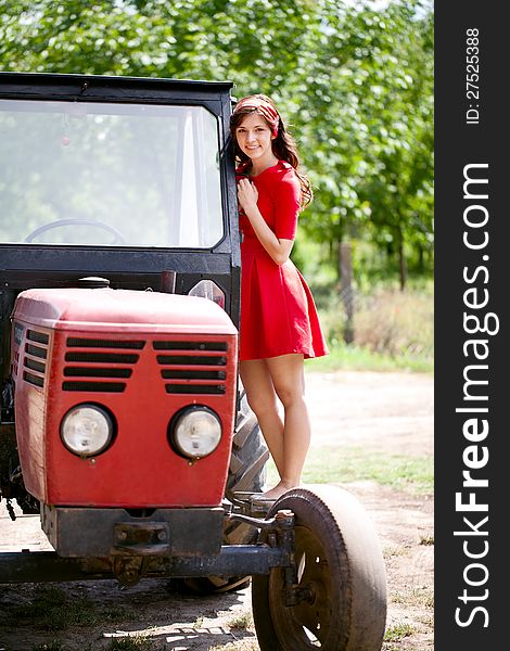 Beautiful farm girl on tractor