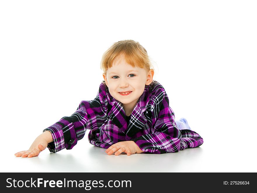 A little girl plays, lies isolated on white background