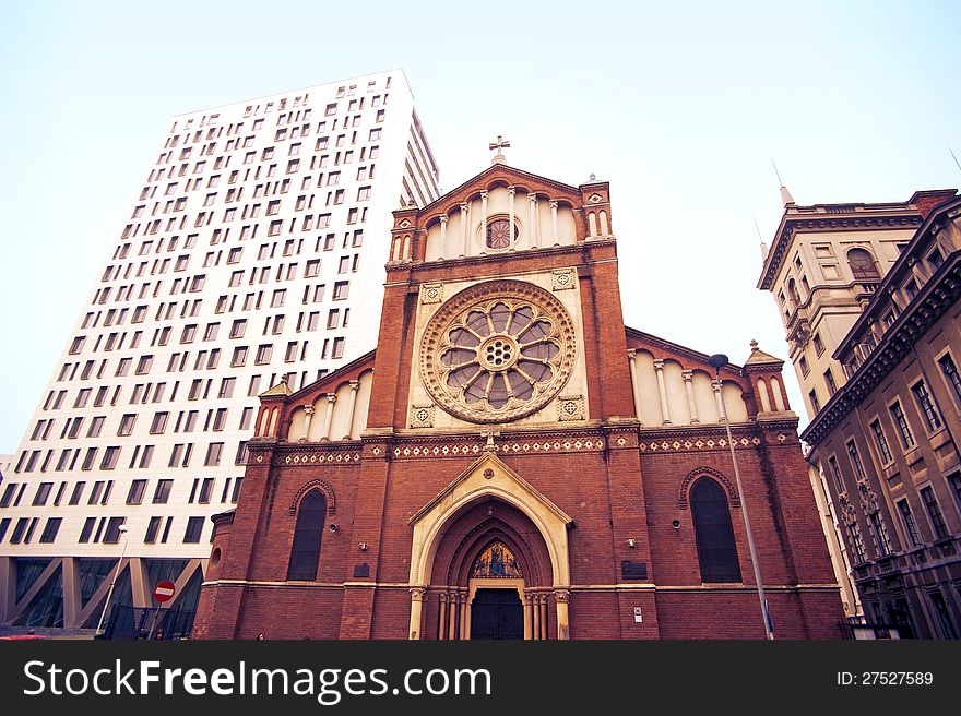 Wide view of Saint Joseph Cathedral surrounded by old and new buildings.Cathedral Plaza and old house.