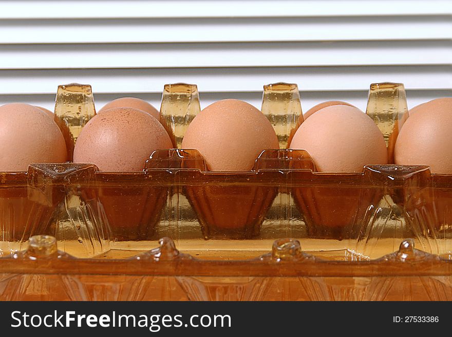 Brownchicken eggs in plastic package.