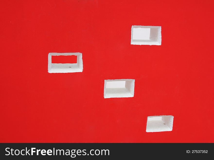 Red wall with white square holes