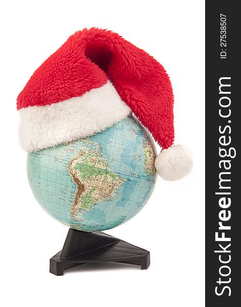 Globe with Santa Claus s hat isolated in white