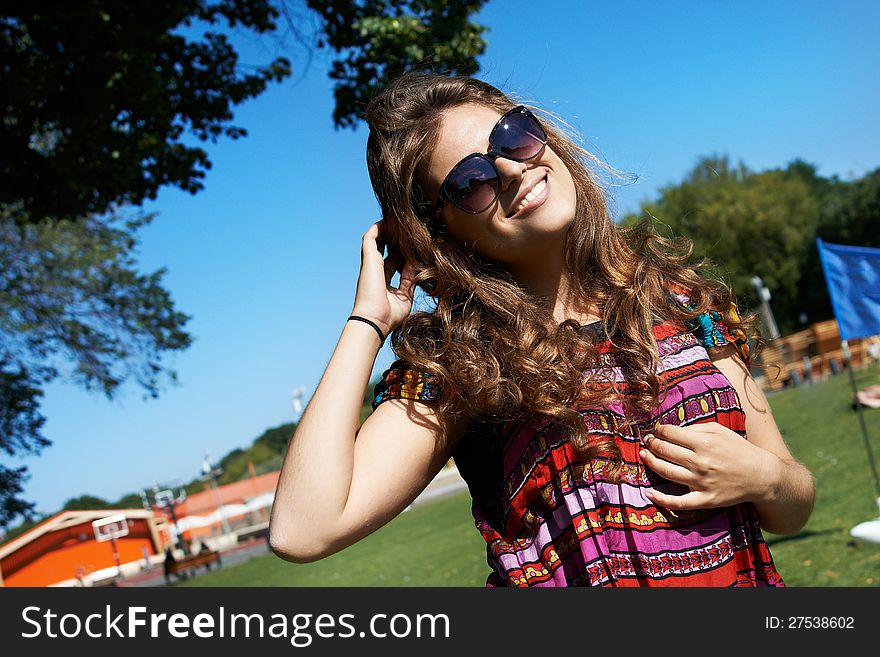 Attractive girl in sunglasses in summer park