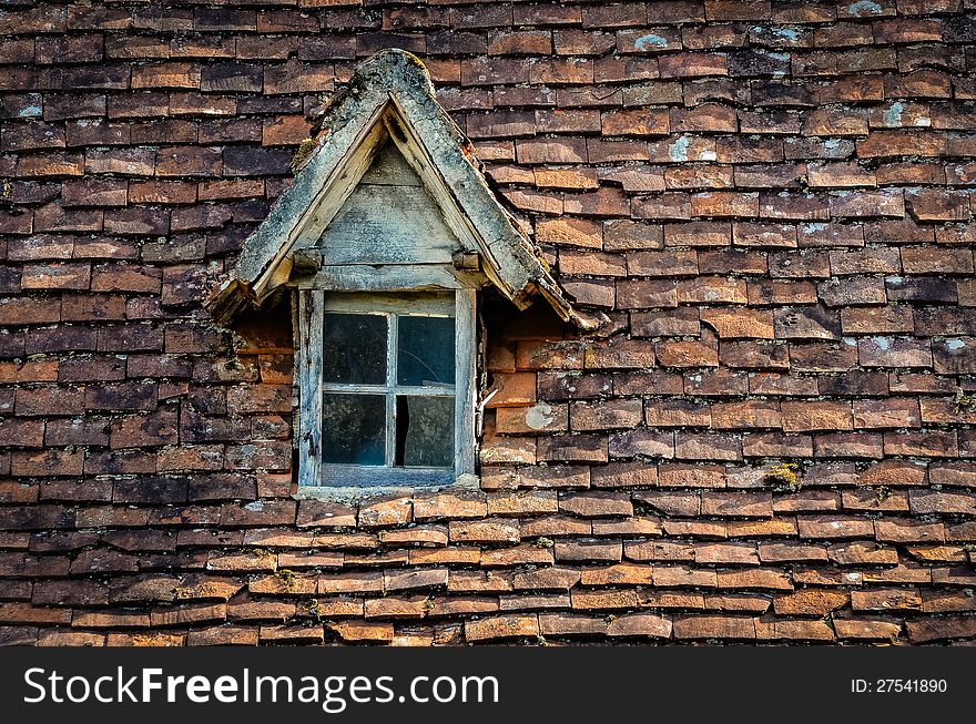 Old Orange Brick Roof With Broken Glass Winow