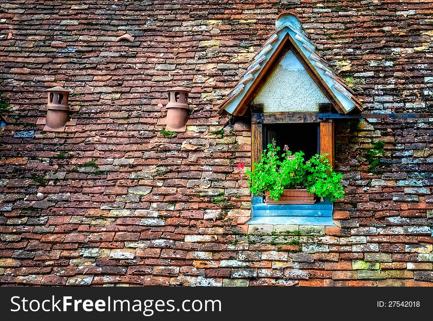 Old Orange Brick Roof With Window And Flowers