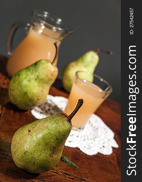 Pear juice with fresh fruit on wooden table