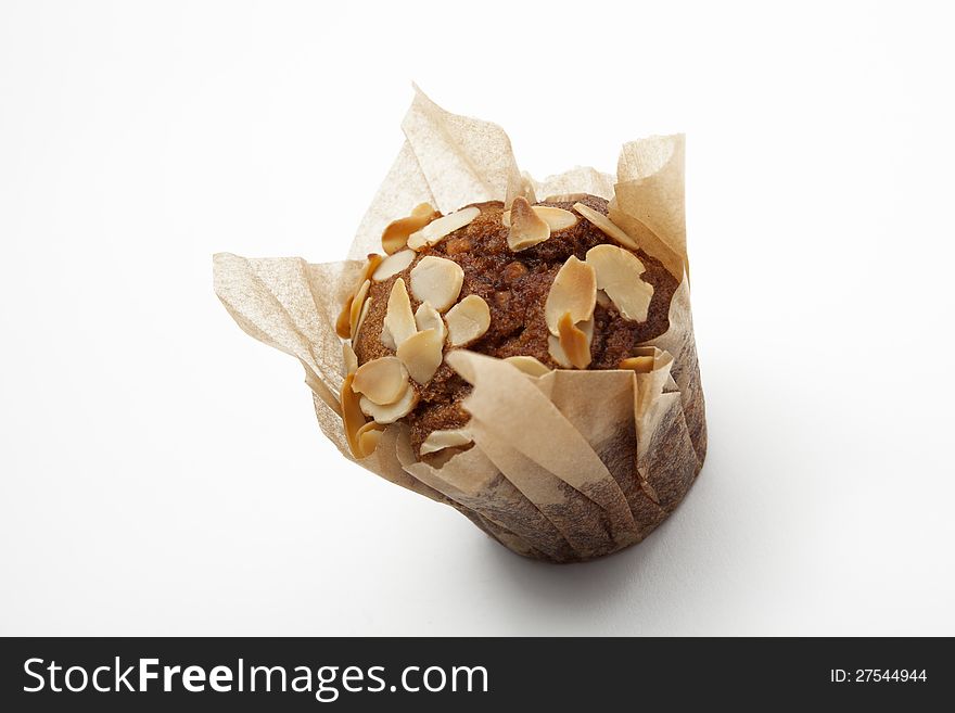 Brown muffin with peanuts isolated on white background. Brown muffin with peanuts isolated on white background