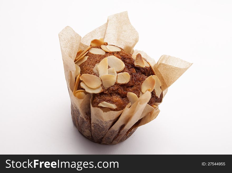 Brown muffin with peanuts isolated on white background. Brown muffin with peanuts isolated on white background