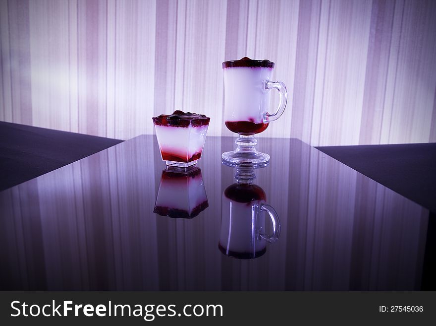 Two glasses with fruit cocktails isolated on black background. Two glasses with fruit cocktails isolated on black background