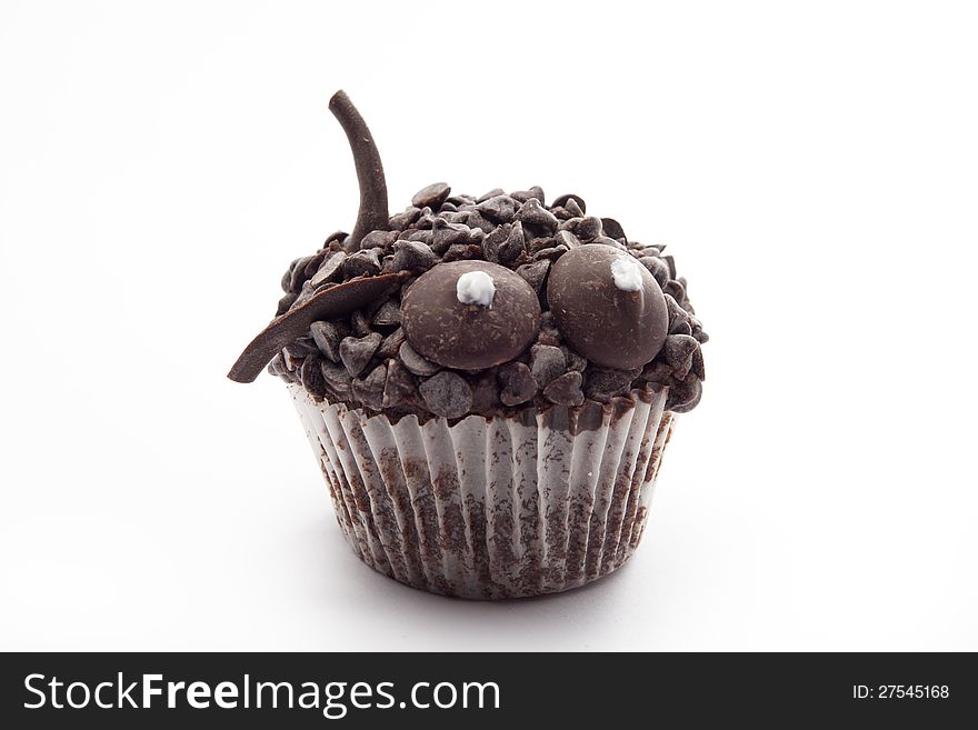 Brown muffin with chocolate isolated on white background. Brown muffin with chocolate isolated on white background