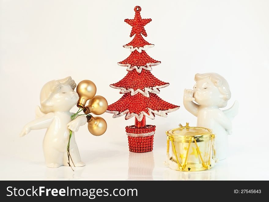 Two decorative angels with Cristmas and New Year decoratins, red X-tree