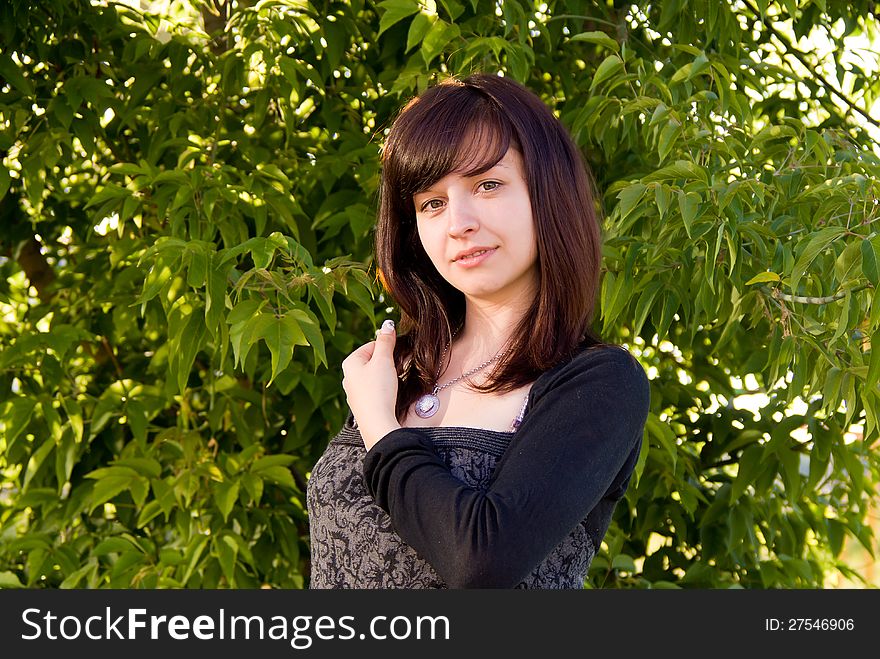 Beautiful girl stands on the nature, the day