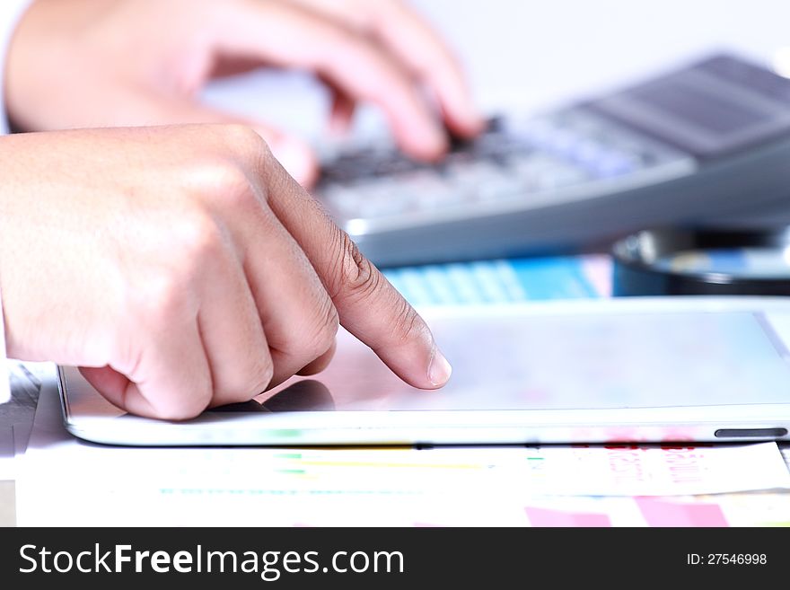 Businessman hand using tablet on the desk