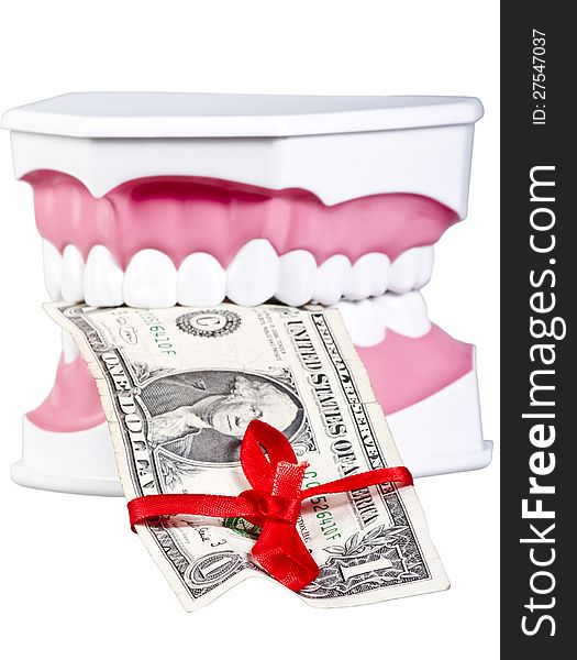 Artificial human jaw with one dollar tied up with a red bow.