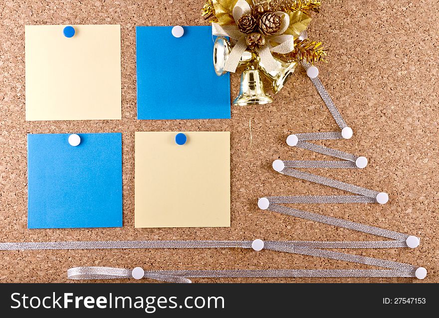 Corkboard with a New Year resolutions empty paper notes, Christmas wreath and improvised silver Christmas tree. Corkboard with a New Year resolutions empty paper notes, Christmas wreath and improvised silver Christmas tree.