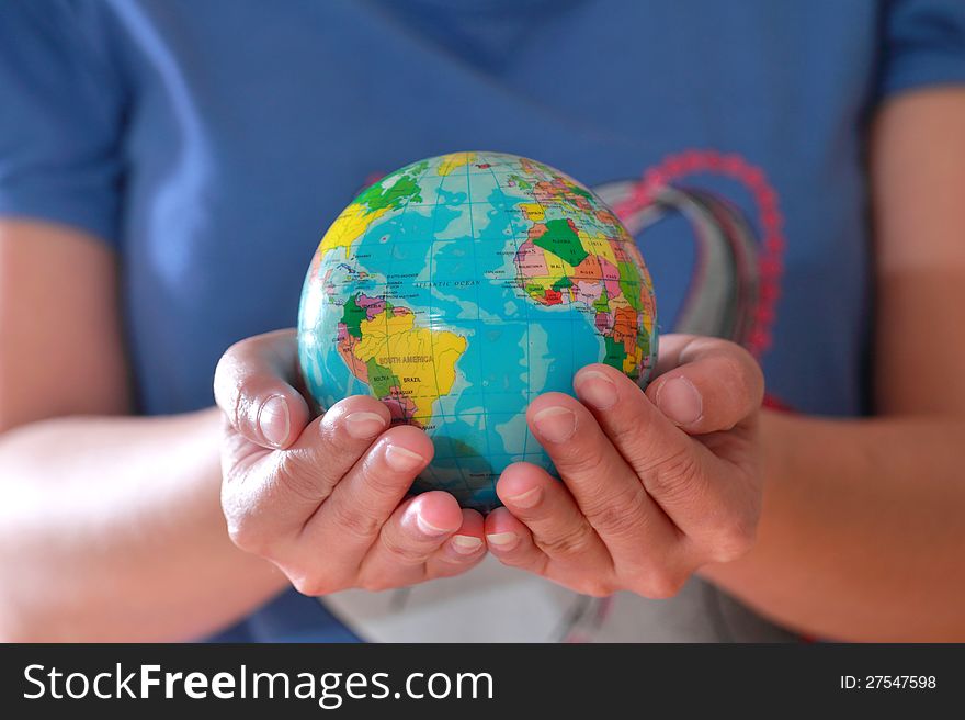 Earth globe in hand