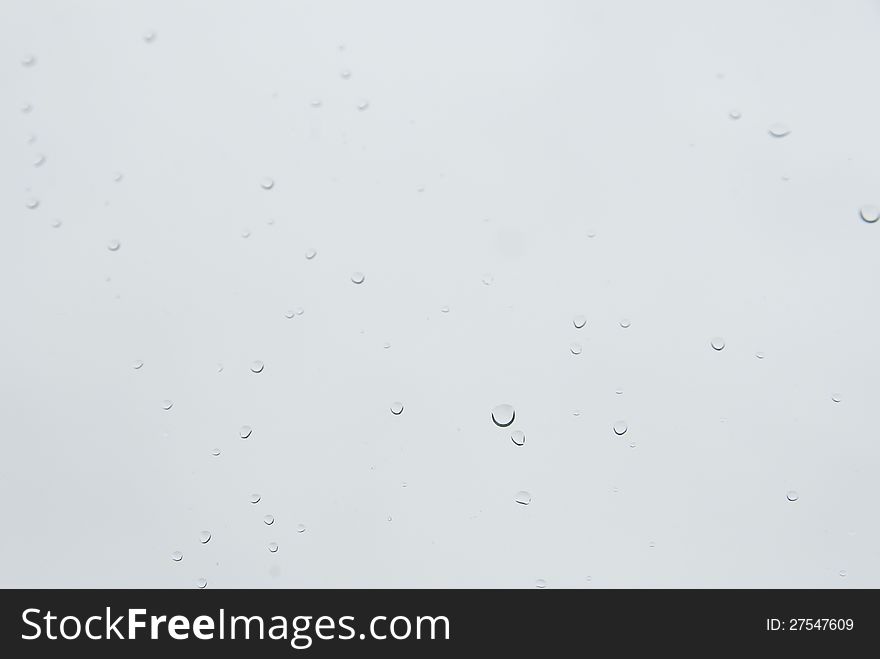 Raindrops on a window glass in a rainy day.