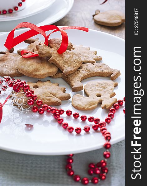 Christmas Gingerbreads with Red Ribbon at the White Plate