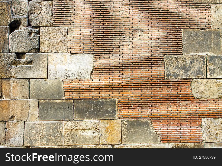 Ancient, repaired brick wall; in horizontal orientation