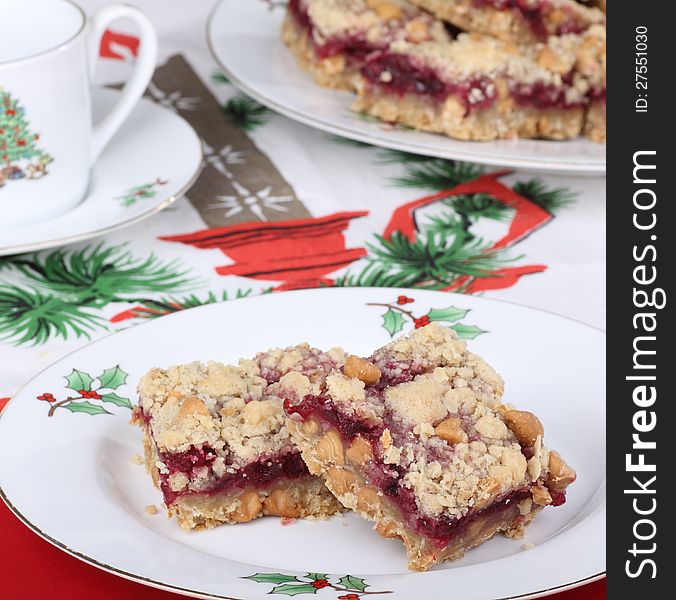 Two cranberry bars on a Christmas plate. Two cranberry bars on a Christmas plate