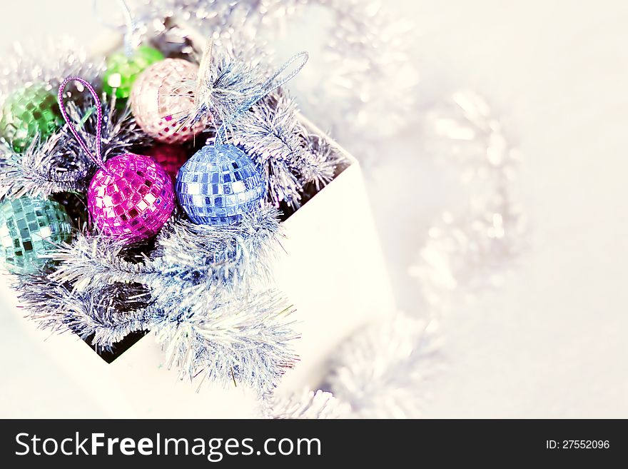 Box with Christmas ornaments on white background