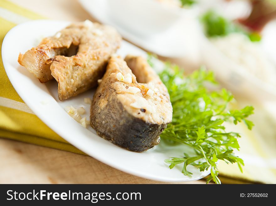 Fried fish on a white plate