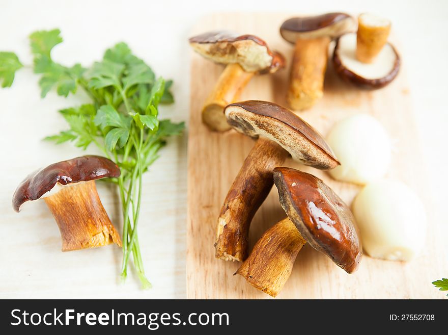 Mushrooms On A Cutting Board And Parsley