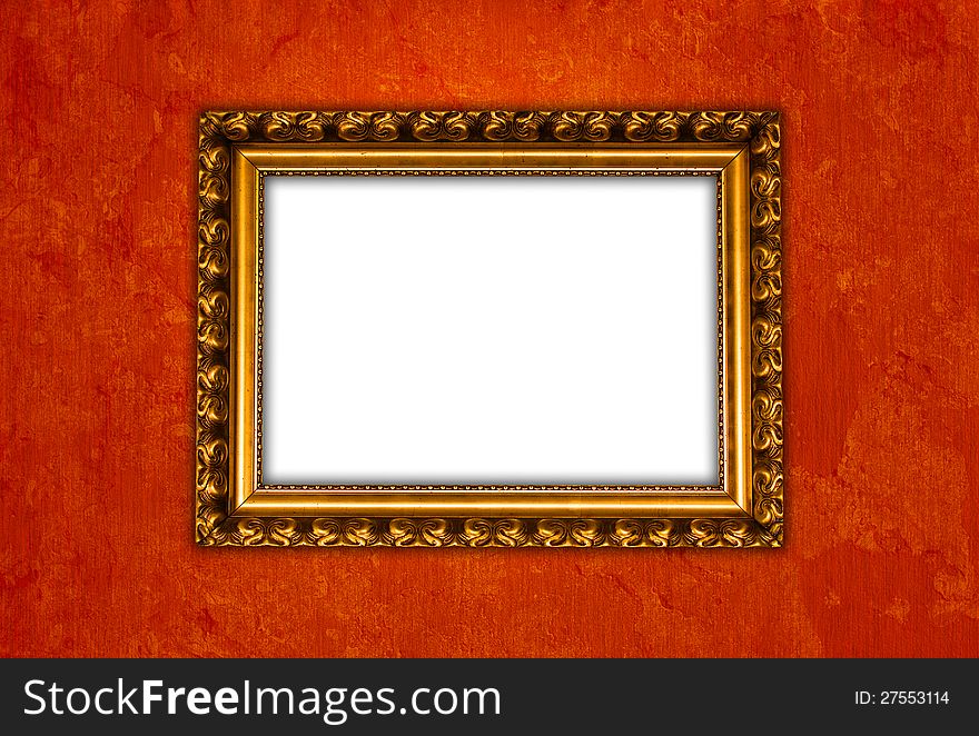 Golden vintage picture frame on red grungy wall