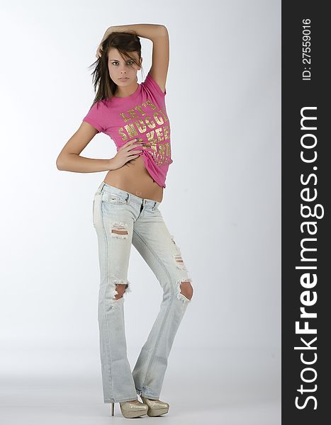 Model posing in pink shirt and jeans. Model posing in pink shirt and jeans