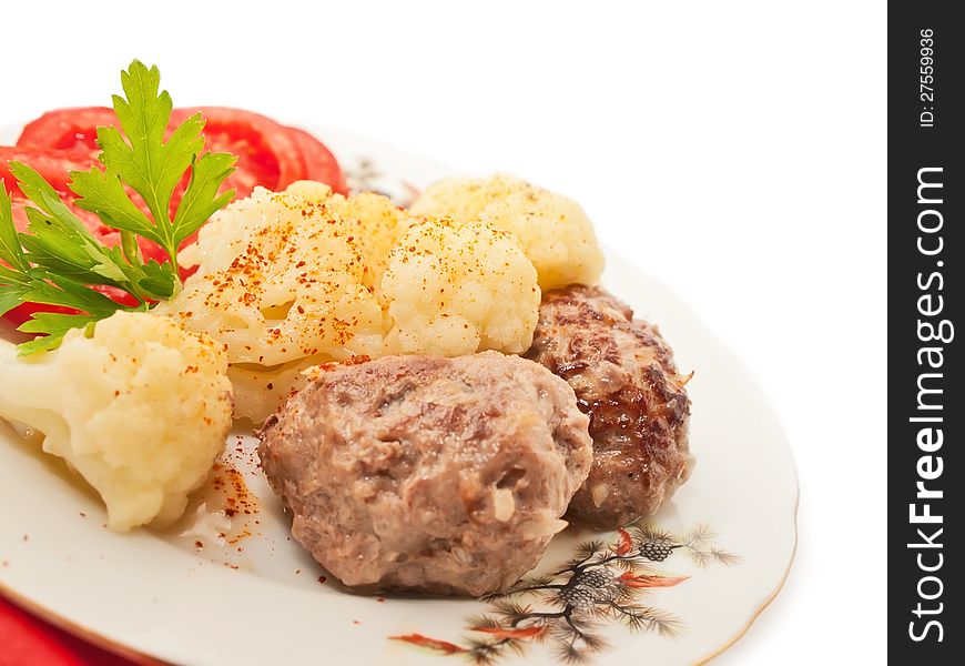 Fried meatballs with cauliflower and tomato on a nice plate