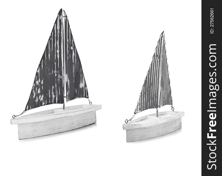 Two white ornamental model boats on a white background