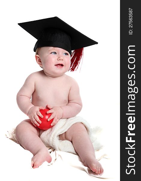Beautiful baby girl with graduation hat on,playing with a red ball. Beautiful baby girl with graduation hat on,playing with a red ball