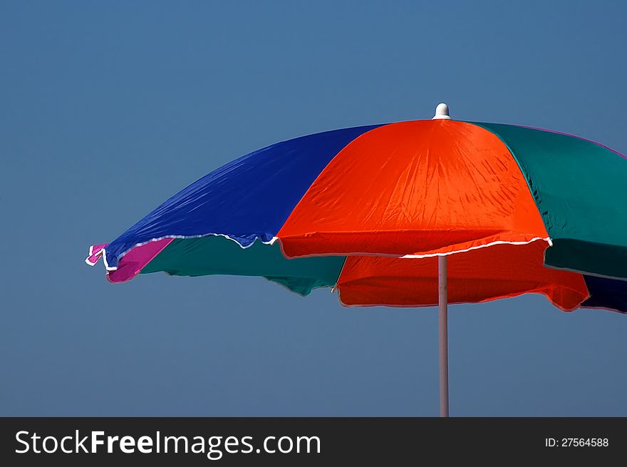Visitors with beach umbrella shade