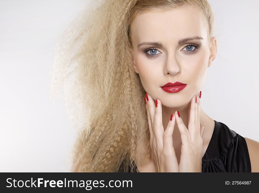 Young pretty woman with beautiful blond hairs and multicolor makeup on white background