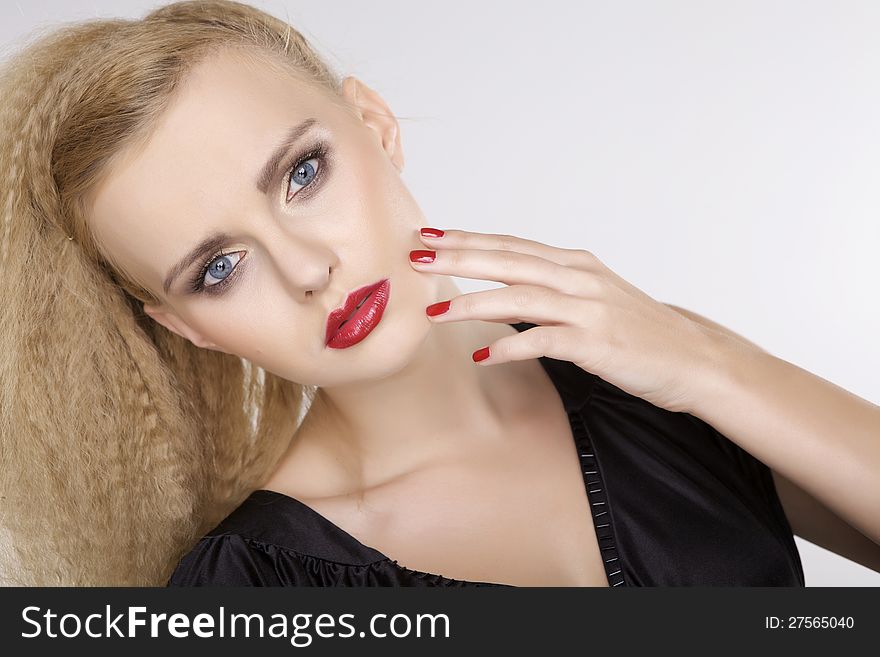 Young pretty woman with beautiful blond hairs and multicolor makeup on white background