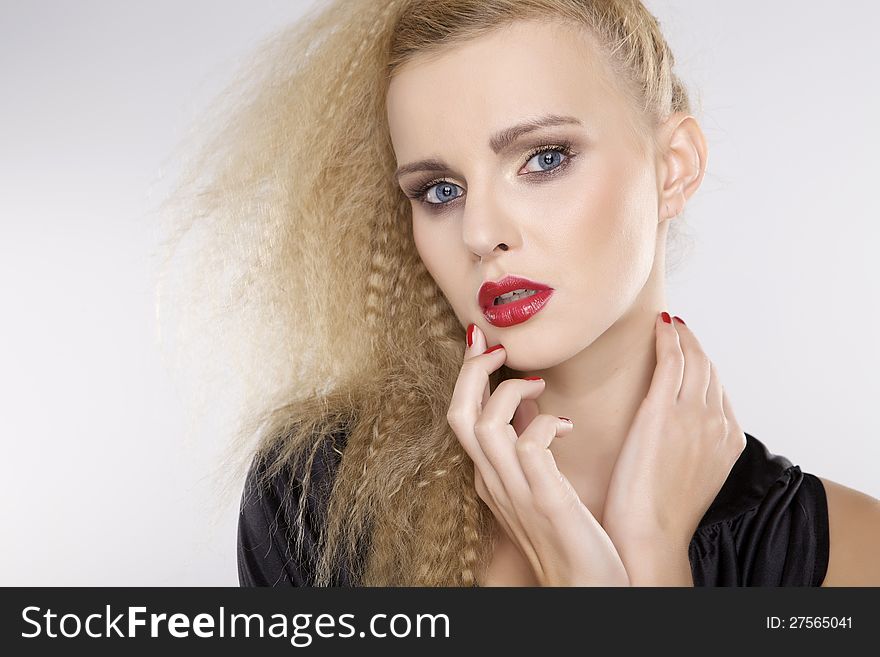 Young pretty woman with beautiful blond hairs and multicolor makeup on white background