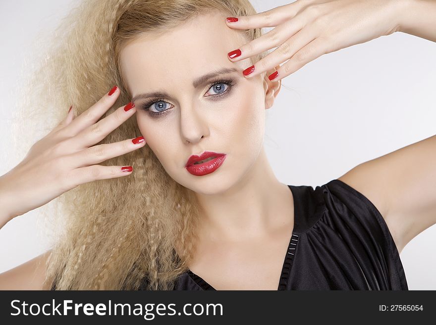 Young pretty woman with beautiful blond hairs and multicolor makeup on white background