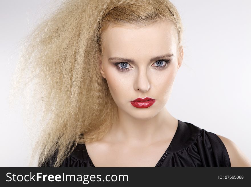 Young pretty woman with beautiful blond hairs and multicolor makeup  on white background