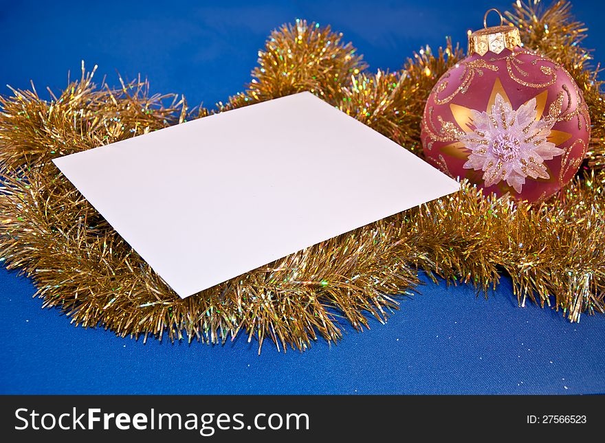 Christmas card with a sphere and tinsel