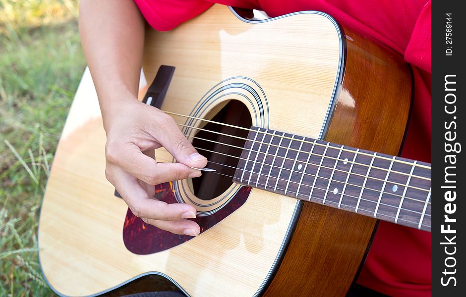 Close up for man playing folk guitar. Close up for man playing folk guitar