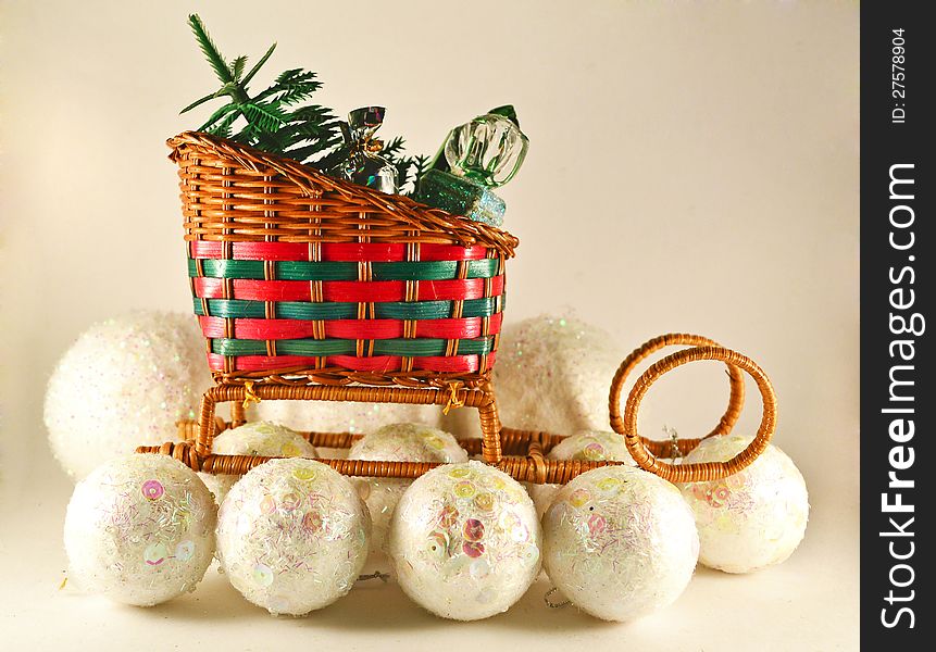 Christmas sledge with gifts and the conifer on the white balls