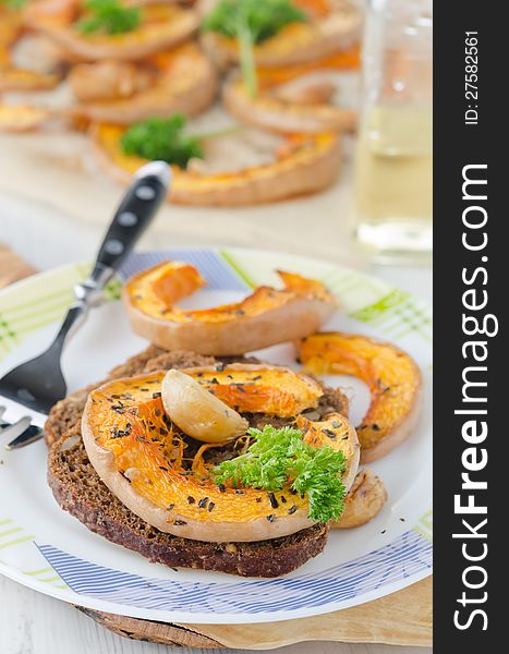 Baked Pumpkin Slices On Pieces Of Corn Bread