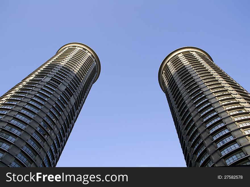 Two round buildings with blue sky. Two round buildings with blue sky