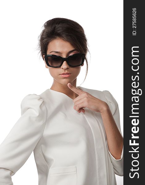 Portrait of pretty brunette in sunglasses posing in the studio on a white background. Portrait of pretty brunette in sunglasses posing in the studio on a white background