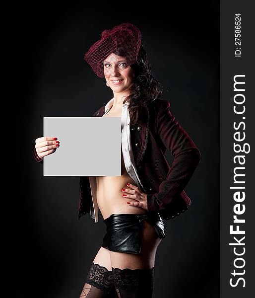 Portrait of sexy woman in erotic clothes showing perfect body on a dark background in the studio. Portrait of sexy woman in erotic clothes showing perfect body on a dark background in the studio