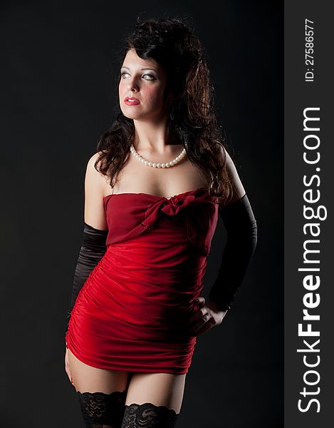 Portrait of expressive brunette posing in sexy dress in the studio on black background. Portrait of expressive brunette posing in sexy dress in the studio on black background